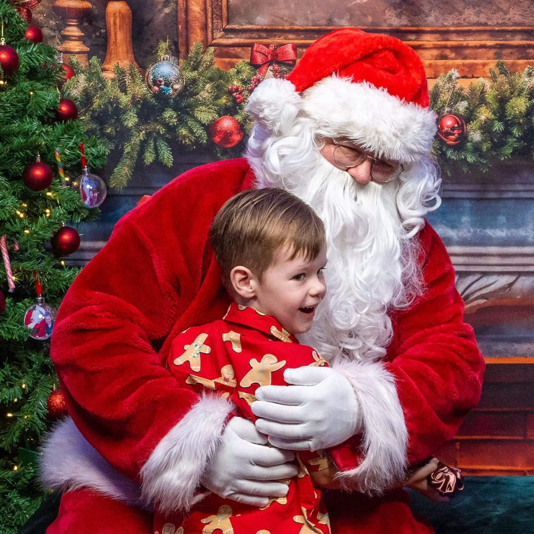 Boy gives Santa a hug